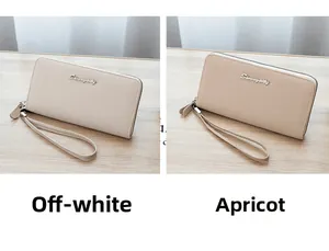 Close-up of cream and apricot lychee leather long wallets with detachable wrist straps
