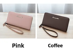 Detail of long leather wallets in pink and brown with wrist straps and metal logos