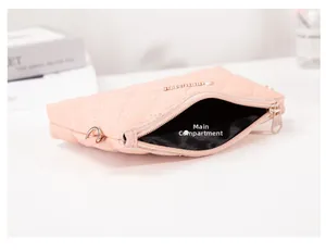 Detailed interior view of pink quilted handbag with main pocket and gold zipper