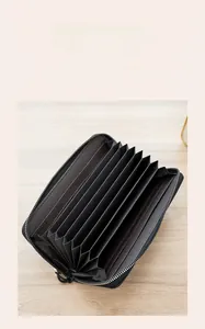 Detail of black cross-grain leather multi-layer accordion wallet with metal zipper