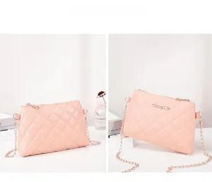 Detailed side view of pink quilted handbag with gold chain strap and metal logo