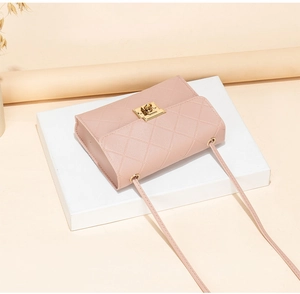 Detailed view of the quilted leather texture and gold metal twist lock on the pink bag