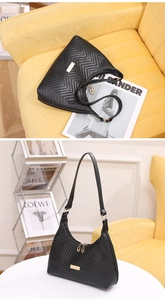 Detail view of black quilted faux leather shoulder bag with gold metal plate and zip