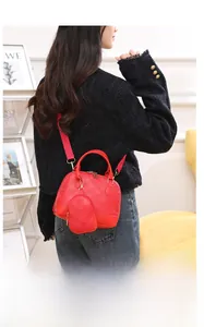 Detail of red quilted Boston handbag set with matching mini pouch and crossbody strap