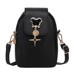 Vertical black crossbody phone bag for women with decorative cat charm and gold hardware