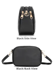 Detail view of black crossbody bag with three zipper compartments and gold heart pulls