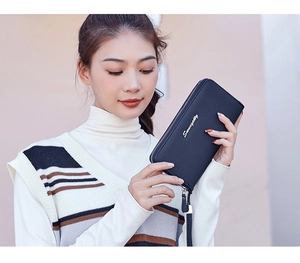 Close-up of black lychee grain long wallet with silver zipper and detachable wrist strap