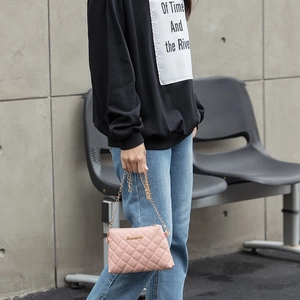 Chic pink quilted crossbody bag with golden chain strap and embroidery detail