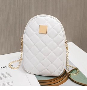 Close-up of white quilted phone bag with golden metal plate and elegant chain strap
