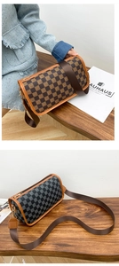Close-up of cylinder boston crossbody bag with letter logo canvas and wide nylon strap