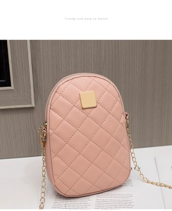 Close-up of pink quilted phone bag showing dual zippers and golden metal plate detail