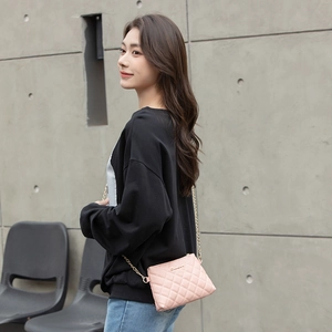 Chic pink quilted crossbody bag with golden chain strap and logo plate for women