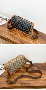 Detail of cylindrical barrel bag featuring checkered print and adjustable nylon strap