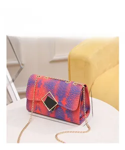 Detail view of snakeskin pattern crossbody bag showing dimensions 21cm by 13cm by 9cm