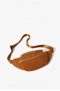 Detailed view of brown corduroy waist bag featuring double gold zippers and nylon strap