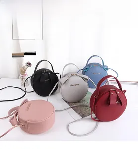 Detailed display of five round crossbody bags in various colors with litchi grain texture