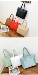Detailed display of large quilted tote bags in seven colors on a wooden bench