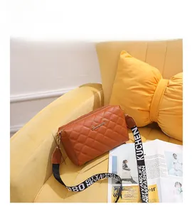 Brown quilted crossbody bag with embroidered strap showing product dimensions 22x13x8cm