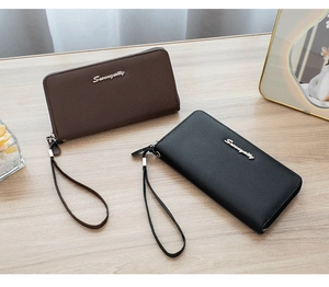 Detailed macro of leather zipper wallets in brown and black with Sunnycity silver logo