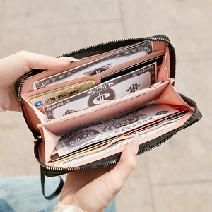 Quilted long bow wallet with pink interior and multi-card slots for organization