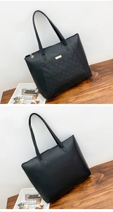 Detail of black tote bag featuring quilted diamond stitching and golden hardware