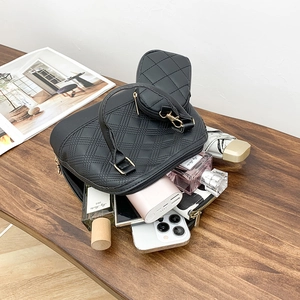 Boston quilted handbag set in black leather showing spacious interior for essentials