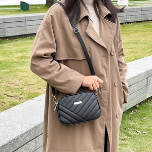 Elegant black quilted crossbody bag with gold metal plate and adjustable strap
