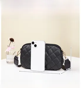 Detailed view of black quilted camera bag with dimensions 20cm x 12cm x 4cm and wide strap