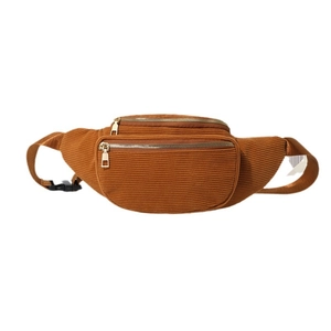 Brown corduroy waist bag with double golden zippers and adjustable strap on white background