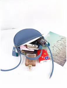 Overhead shot of blue lychee grain circular bag showing spacious interior compartment