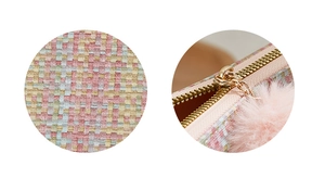 Détail de la texture en tweed multicolore et zip doré avec pompon en peluche rose