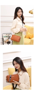 Detail of brown quilted faux leather handbag with wide logo strap and gold hardware