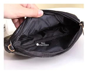 Close-up of the main compartment and interior lining of this black quilted camera bag