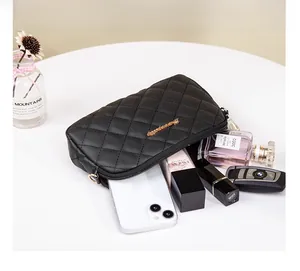 Interior capacity of quilted black crossbody bag showing phone, lipstick and perfume