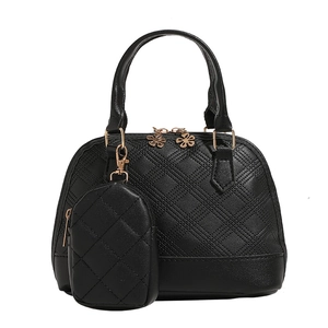 Quilted black shell handbag with matching mini square pouch and floral zipper charm