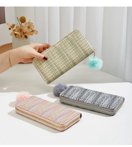 Détail des portefeuilles longs tissés à carreaux vert, gris et rose avec pompon décoratif doux