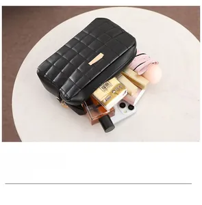 Top view of quilted black leather camera bag showing spacious storage for cosmetics and phone
