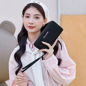 Women's black pebbled leather long wallet with zipper closure and detachable wristlet strap