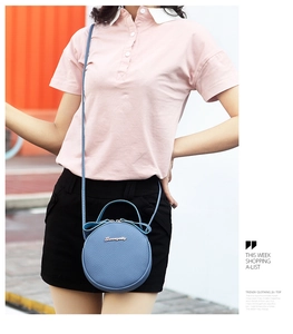 Sky blue circular crossbody bag with litchi grain texture and gold metallic logo detail