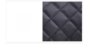 Close-up detail of black quilted leather material with classic rhombus stitching pattern