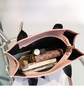 Pink quilted handbag showing spacious interior with cosmetics, wallet and power bank