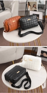 Detail showing quilted texture and metal hardware on a stylish crossbody bag