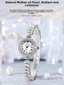 Macro view of a women's silver watch with shell dial and leaf-shaped rhinestone band