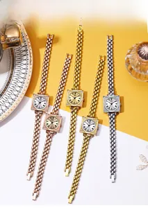Close-up of vintage square women's watches in rose gold and silver with rhinestones
