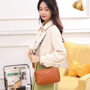 Brown quilted crossbody bag with embroidered pattern and stylish BAG 1980 wide strap