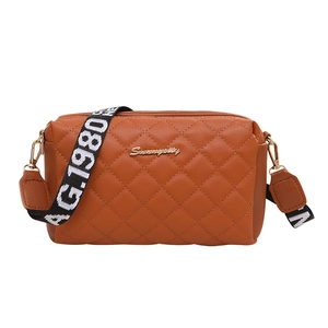 Brown quilted crossbody bag with golden zippers and wide jacquard woven strap