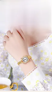 Close-up of vintage square quartz watch with gold metal strap and roman numerals