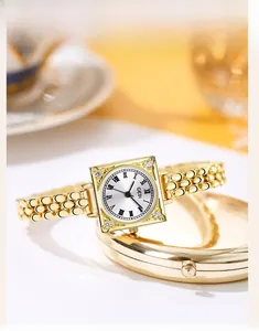 Macro view of vintage gold square quartz watch with Roman numerals and diamond accents