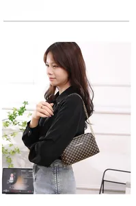 Classic brown monogram crossbody bag with elegant gold chain strap on model side view