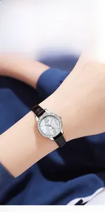 Macro detail of GEDI luxury watch with sparkling rhinestone bezel and black leather strap